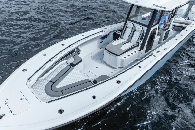 Slide: The Image of 2025 Yellowfin 36 Offshore boat cruising on open water, showcasing sleek design and spacious seating. - 15