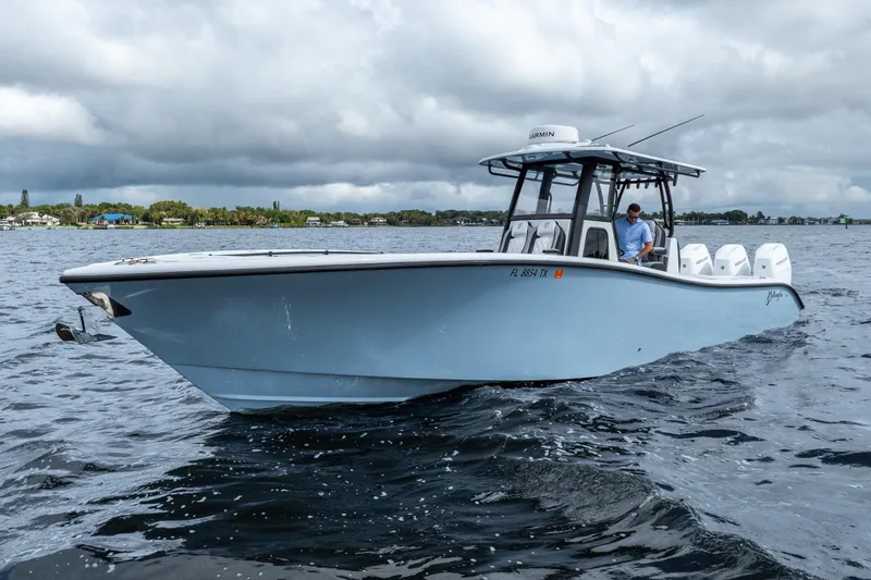 Slide: The Image of 2025 Yellowfin 36 Offshore boat on water under cloudy sky. - 16