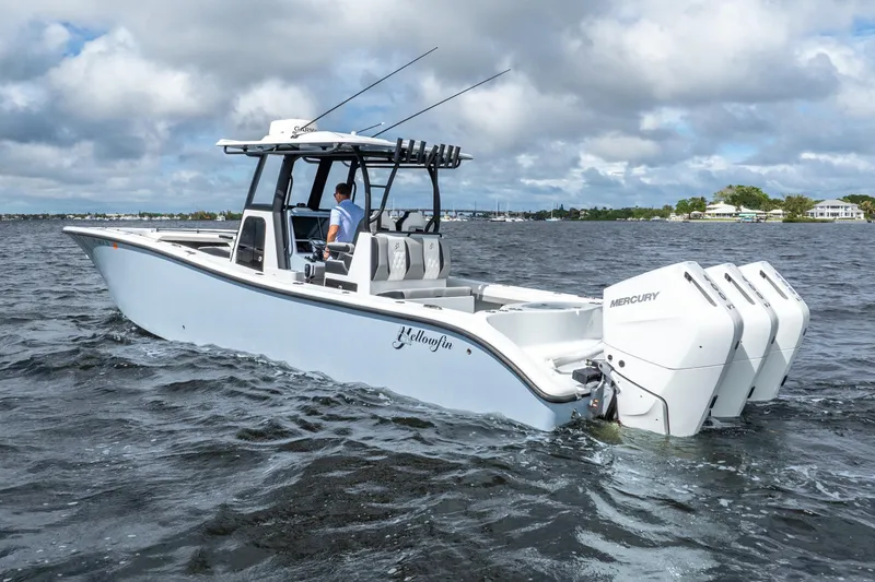 Slide: The Image of 2025 Yellowfin 36 Offshore boat with triple Mercury engines on open water. - 18