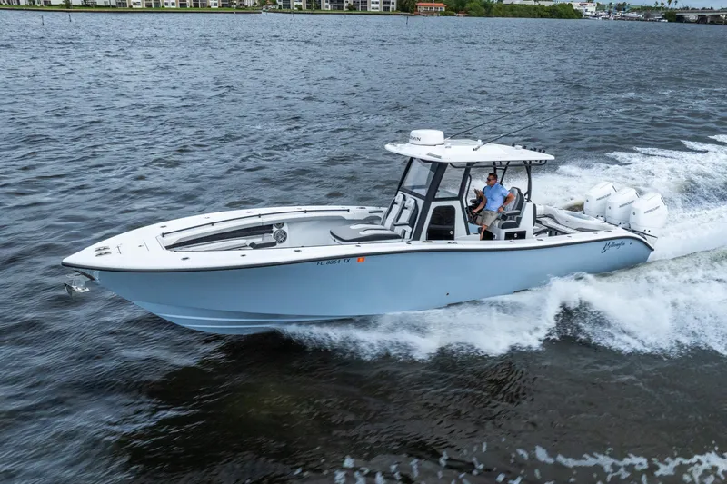 Slide: The Image of 2025 Yellowfin 36 Offshore boat cruising on water, showcasing sleek design and powerful engines. - 2