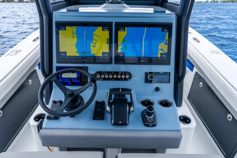 Slide: The Image of Helm of 2025 Yellowfin 36 Offshore boat with dual navigation screens and controls. - 21