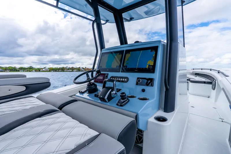 Slide: The Image of 2025 Yellowfin 36 Offshore boat cockpit with advanced navigation screens and luxurious seating. - 23