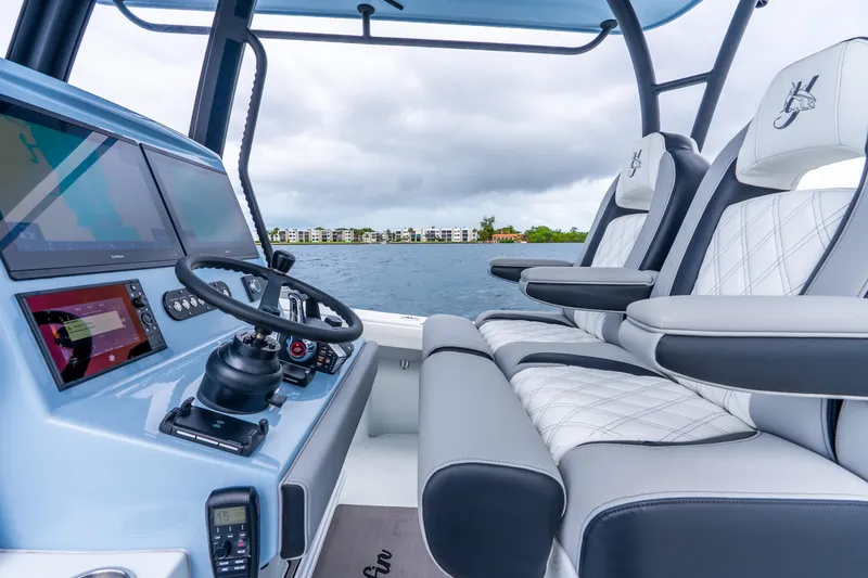 Slide: The Image of 2025 Yellowfin 36 Offshore boat interior with modern dashboard and luxurious seating. - 25