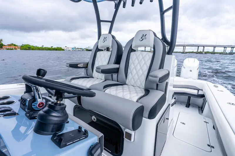 Slide: The Image of 2025 Yellowfin 36 Offshore boat interior with luxury seating and steering wheel on open water. - 26