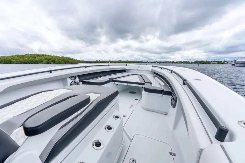 Slide: The Image of 2025 Yellowfin 36 Offshore boat interior with sleek seating and overcast sky. - 28