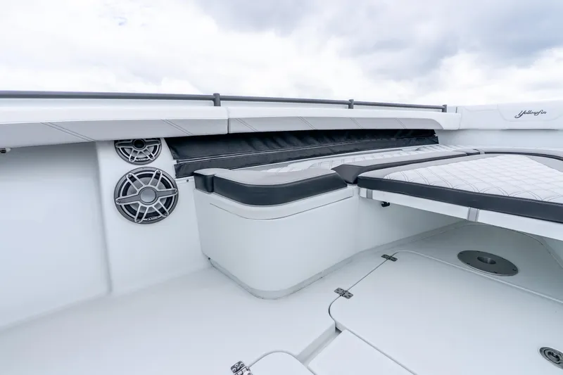 Slide: The Image of 2025 Yellowfin 36 Offshore boat interior with cushioned seating and built-in speakers. - 31