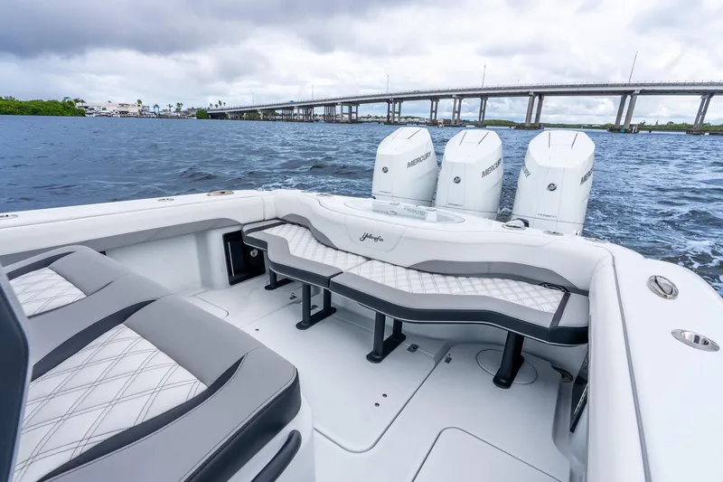 Slide: The Image of 2025 Yellowfin 36 Offshore boat with triple Mercury engines on a scenic waterway. - 33