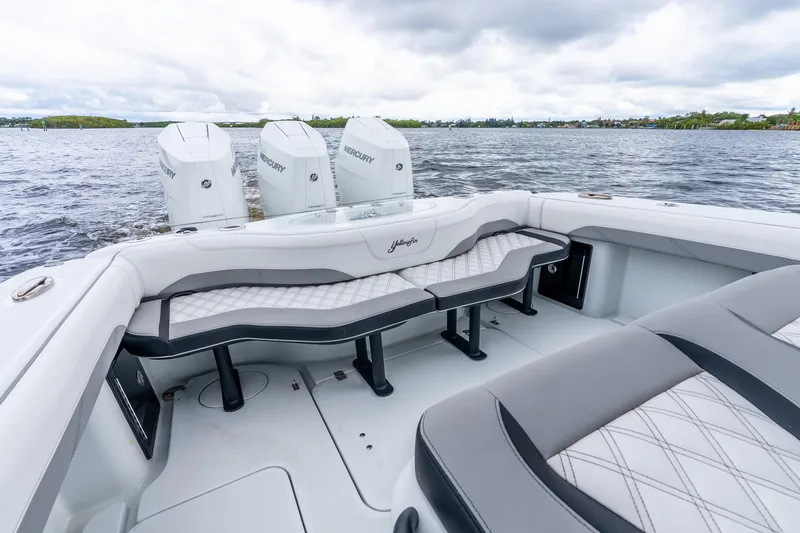 Slide: The Image of 2025 Yellowfin 36 Offshore boat with triple Mercury engines on a calm lake. - 34