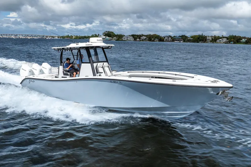 Slide: The Image of 2025 Yellowfin 36 Offshore boat cruising on open water under cloudy skies. - 4