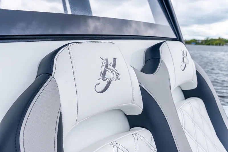 Slide: The Image of 2025 Yellowfin 36 Offshore boat seats with embroidered marlin logo, near water. - 41
