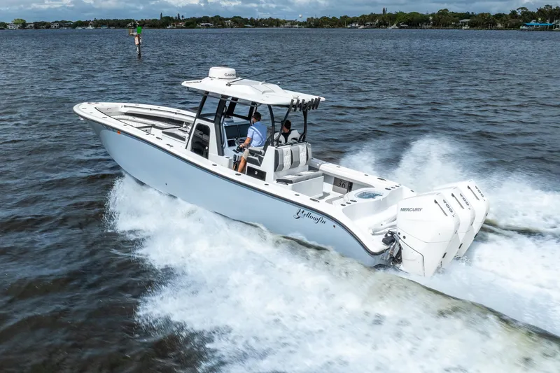 Slide: The Image of 2025 Yellowfin 36 Offshore boat cruising on open water with triple Mercury engines. - 7