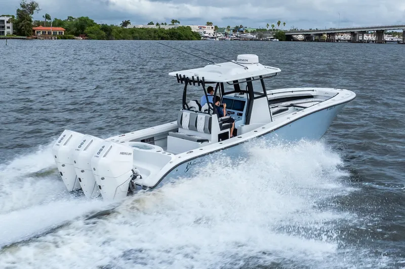 Slide: The Image of 2025 Yellowfin 36 Offshore boat cruising on open water with triple Mercury engines. - 8