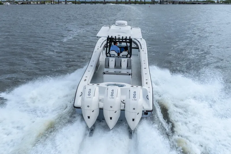 Slide: The Image of 2025 Yellowfin 36 Offshore boat speeding on water with triple 400 engines. - 9