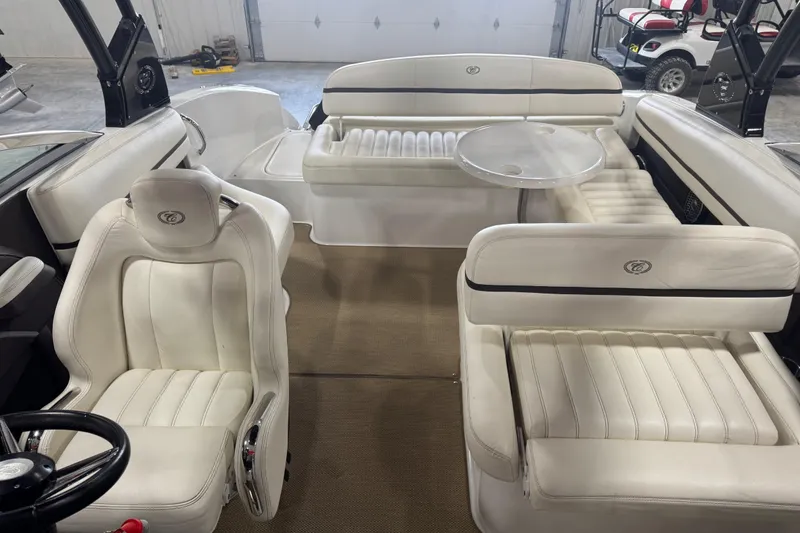 Slide: The Image of Interior of a 2014 Cobalt R5 boat with white leather seating and a small table. - 10