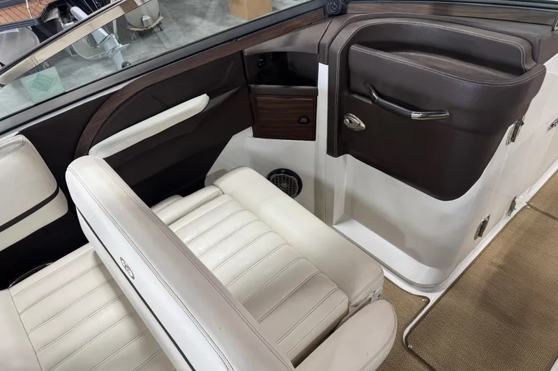 Slide: The Image of Interior of a 2014 Cobalt R5 boat featuring white leather seats and brown accents. - 12