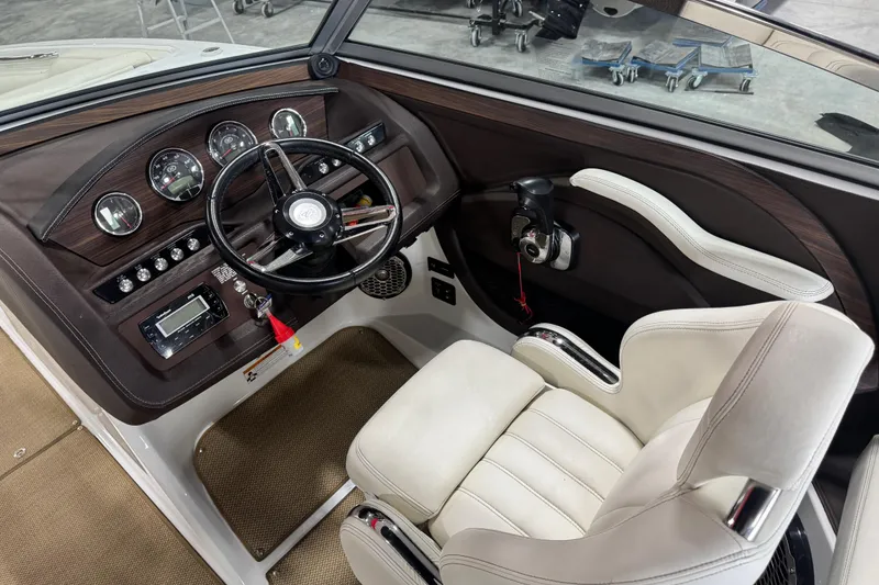 Slide: The Image of Interior of a 2014 Cobalt R5 boat featuring steering wheel and control panel. - 13