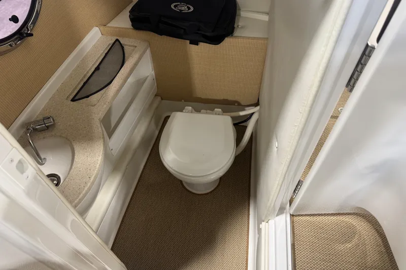 Slide: The Image of Compact bathroom in a 2014 Cobalt R5 boat with sink and toilet. - 14