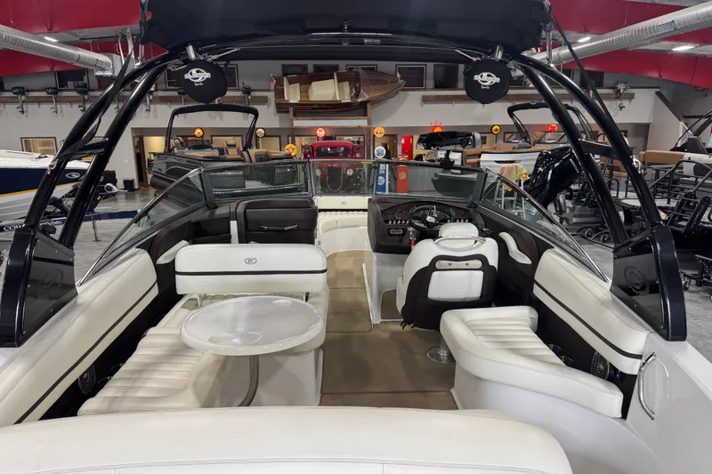 Slide: The Image of Interior view of a 2014 Cobalt R5 boat with white seating and modern dashboard. - 6
