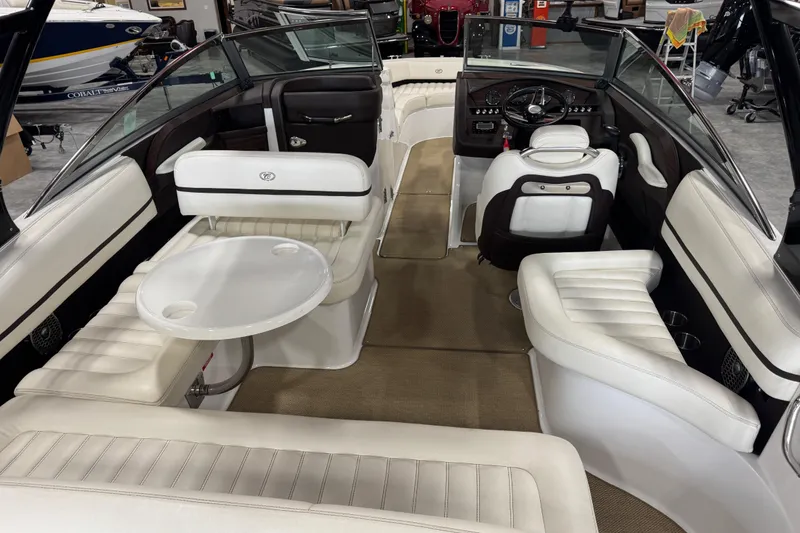 Slide: The Image of Interior of a 2014 Cobalt R5 boat with white seating and a round table. - 7