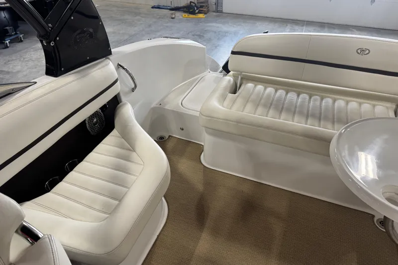 Slide: The Image of Interior of a 2014 Cobalt R5 boat with white leather seating and beige carpet. - 8