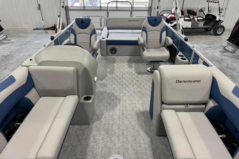 Slide: The Image of Interior of a 2026 Berkshire 24 UL RE pontoon boat with plush seating and modern design. - 12
