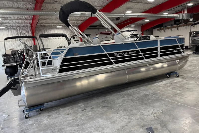 Slide: The Image of 2026 Berkshire 24 UL RE pontoon boat in a showroom, featuring sleek design and modern amenities. - 3