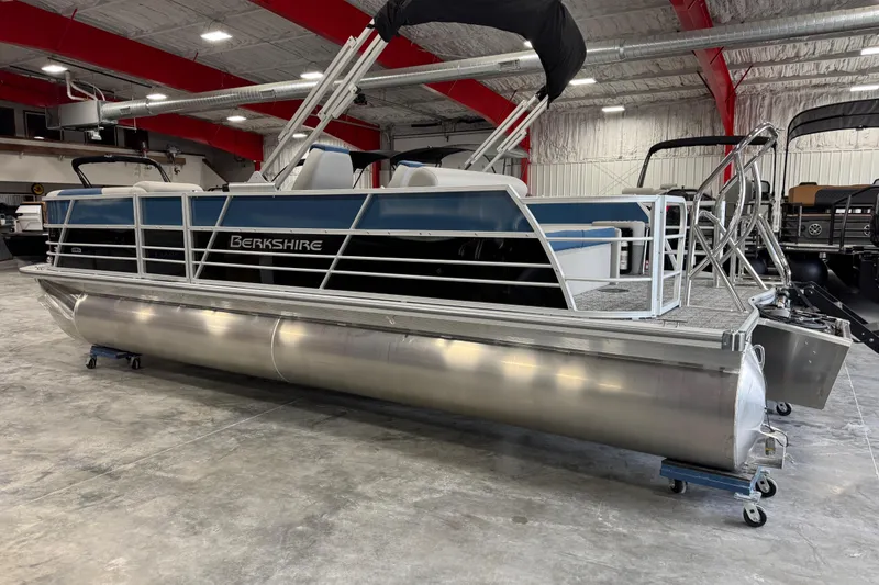 Slide: The Image of 2026 Berkshire 24 UL RE pontoon boat in a showroom with red beams. - 4
