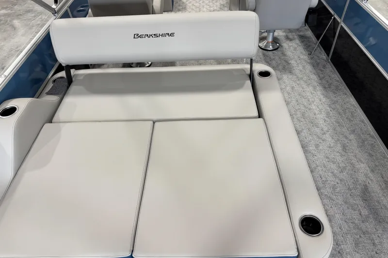 Slide: The Image of 2026 Berkshire 24 UL RE boat interior with cushioned seating and cup holders. - 8