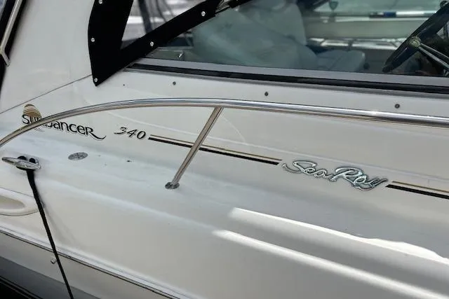 Slide: The Image of A close-up of a Sea Ray Sundancer 340 boat exterior, showcasing sleek design details. - 12