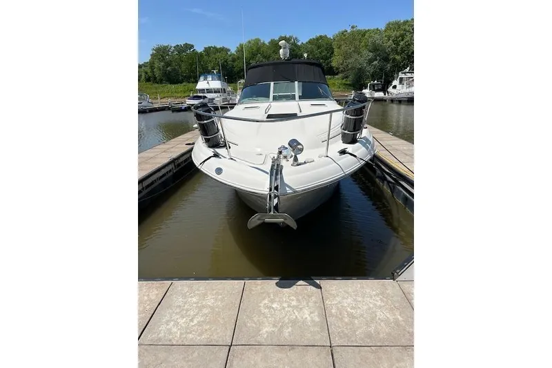 Slide: The Image of 2009 Meridian 391 Sedan yacht docked in a marina, surrounded by calm water and greenery. - 18