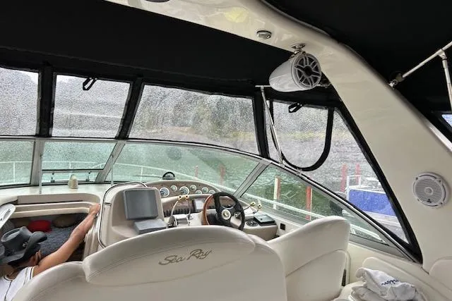 Slide: The Image of Interior view of a 2009 Meridian 391 Sedan boat cockpit with steering wheel and controls. - 2