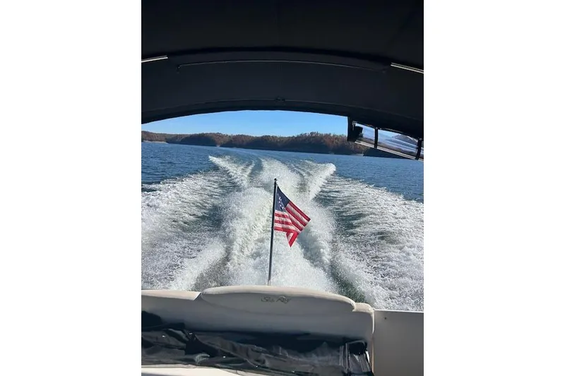 Slide: The Image of Wake behind 2009 Meridian 391 Sedan boat with American flag on a sunny day. - 20