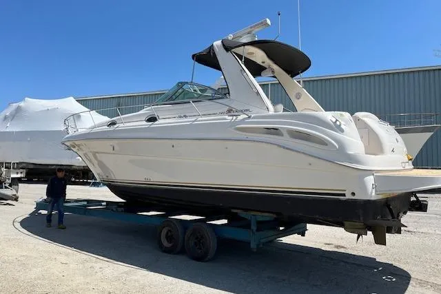 Slide: The Image of 2009 Meridian 391 Sedan boat on trailer, parked outdoors under clear blue sky. - 21