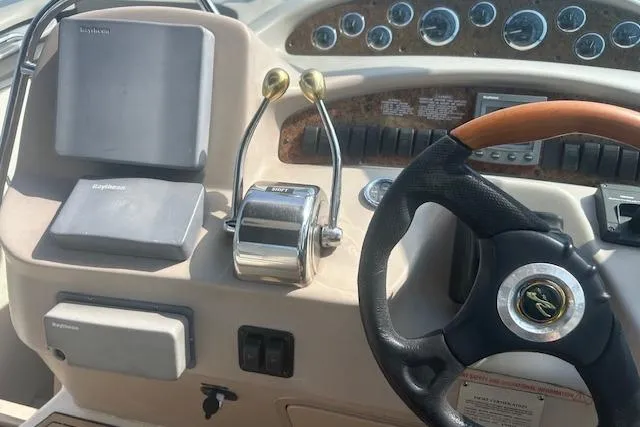 Slide: The Image of 2009 Meridian 391 Sedan helm with steering wheel, throttle controls, and navigation equipment. - 4