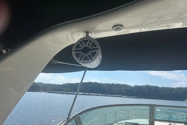 Slide: The Image of 2009 Meridian 391 Sedan boat with speaker, overlooking serene lake and distant shoreline. - 8