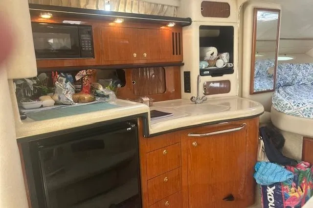 Slide: The Image of Interior of a 2009 Meridian 391 Sedan yacht with kitchen and cozy sleeping area. - 9