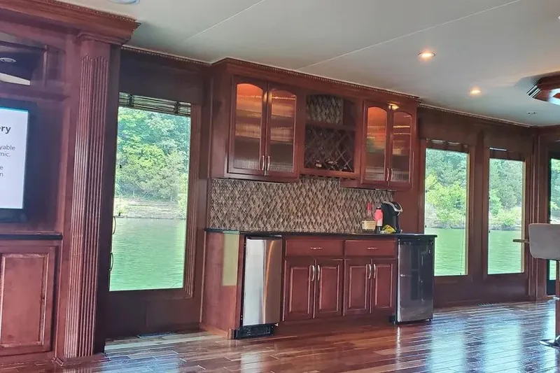 Slide: The Image of Luxurious 2012 Thoroughbred Houseboat interior with elegant wood cabinetry and scenic lake views. - 3