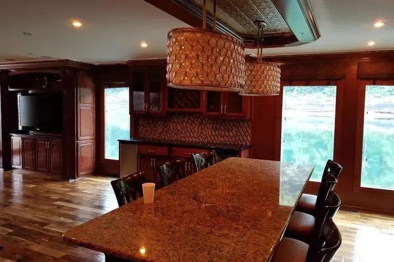 Slide: The Image of Luxurious interior of 2012 Thoroughbred Houseboat 21x103 with elegant wood finishes and modern amenities. - 6