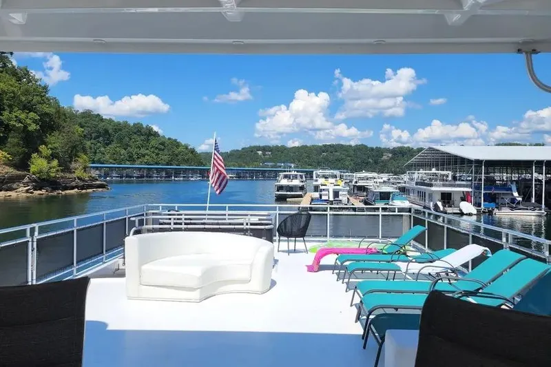 Slide: The Image of Luxurious 2012 Thoroughbred Houseboat 21x103 with scenic lake view and comfortable deck seating. - 8