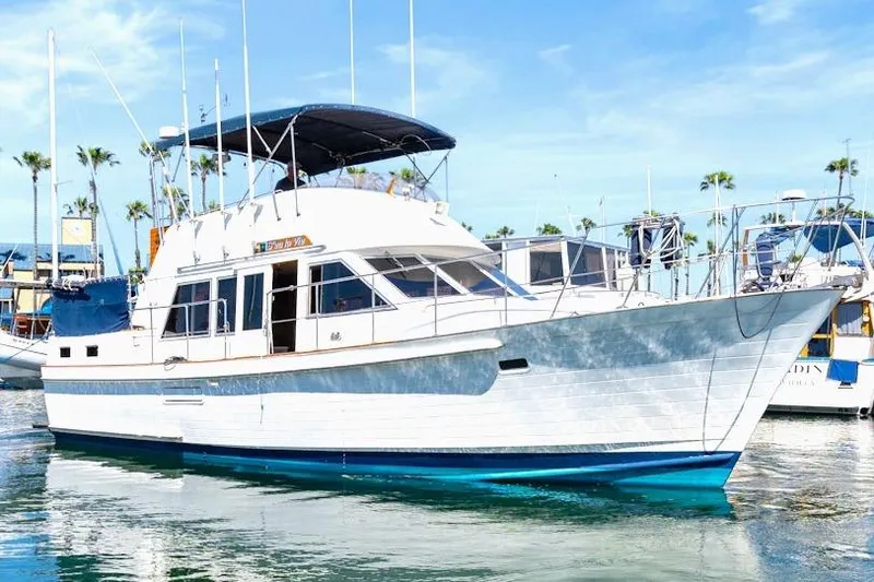 Slide: The Image of 1986 Island Gypsy 40 Motor Yacht docked in a sunny marina. - 1