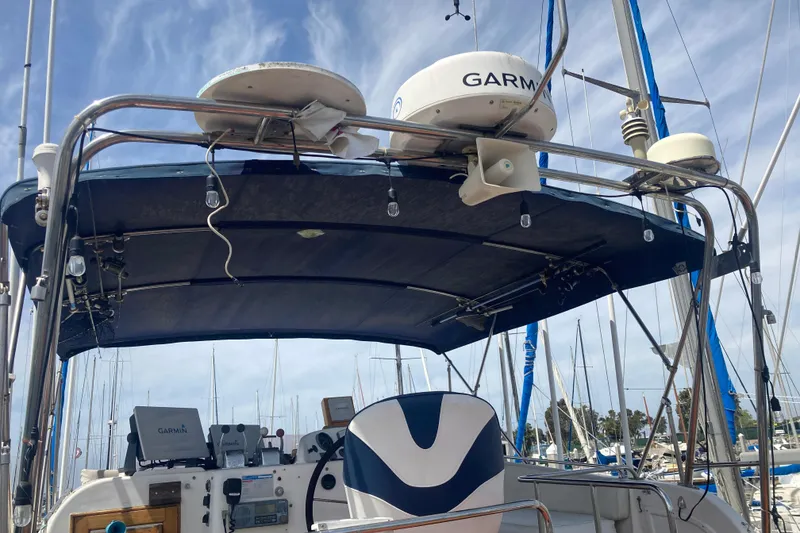 Slide: The Image of 1986 Island Gypsy 40 Motor Yacht helm with Garmin equipment, docked in a marina. - 12