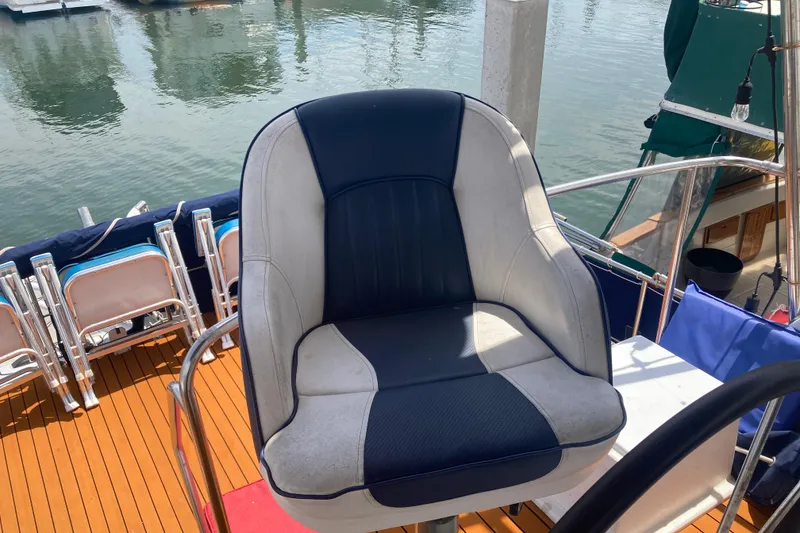 Slide: The Image of Captain's chair on 1986 Island Gypsy 40 Motor Yacht, overlooking marina waters. - 15