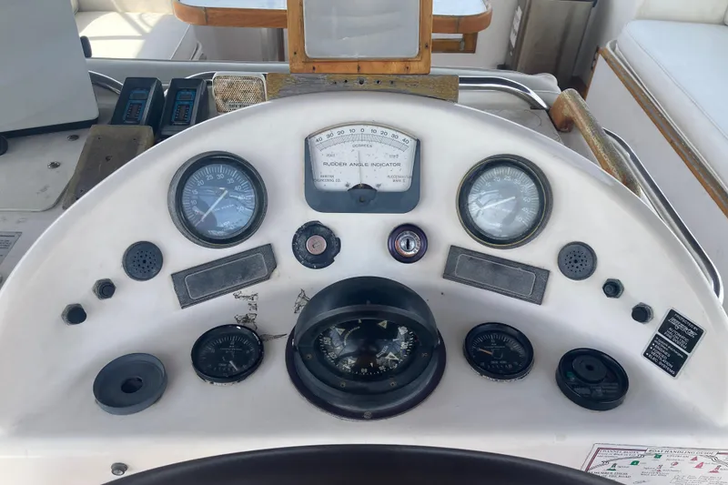 Slide: The Image of Control panel of a 1986 Island Gypsy 40 Motor Yacht with gauges and compass. - 16