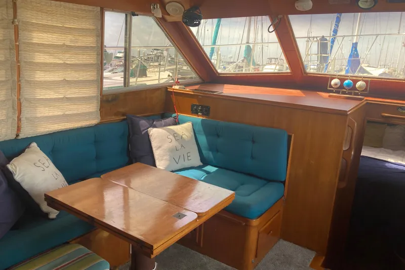 Slide: The Image of Interior of 1986 Island Gypsy 40 Motor Yacht with blue seating and nautical decor. - 33