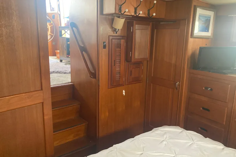 Slide: The Image of Interior of 1986 Island Gypsy 40 Motor Yacht with wooden cabinetry and cozy furnishings. - 36