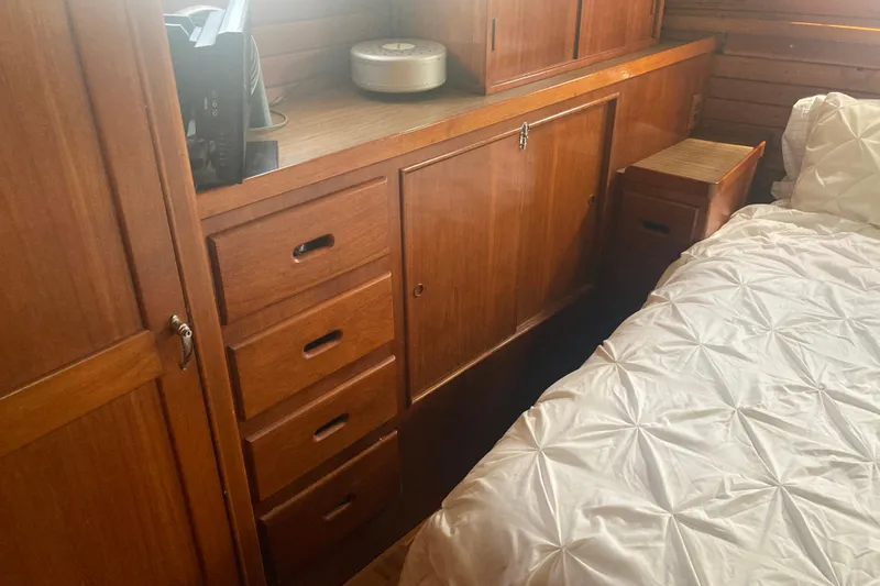 Slide: The Image of Interior of 1986 Island Gypsy 40 Motor Yacht with wooden cabinetry and bed. - 37