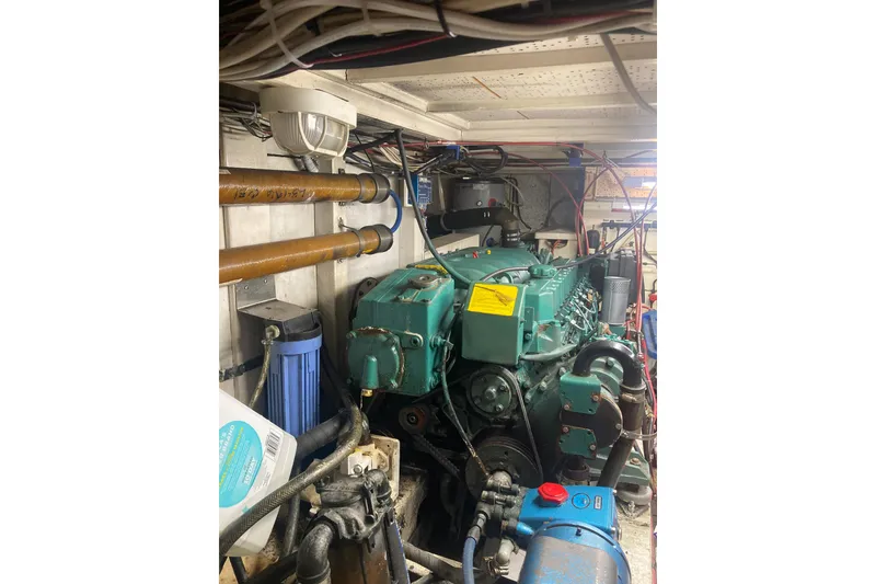 Slide: The Image of Engine room of 1986 Island Gypsy 40 Motor Yacht with visible machinery and wiring. - 45