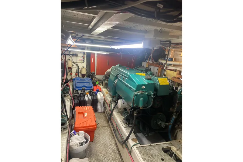 Slide: The Image of Engine room of a 1986 Island Gypsy 40 Motor Yacht with equipment and supplies. - 47