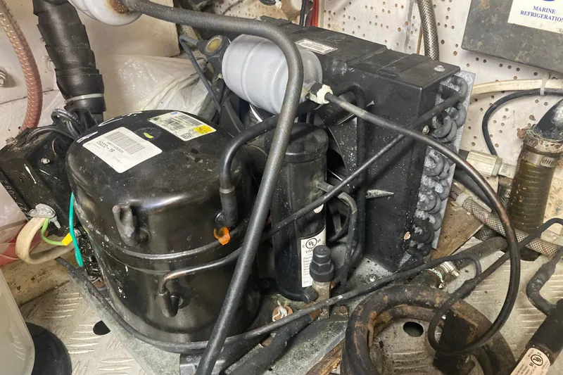 Slide: The Image of Engine room of 1986 Island Gypsy 40 Motor Yacht showing marine refrigeration unit. - 52