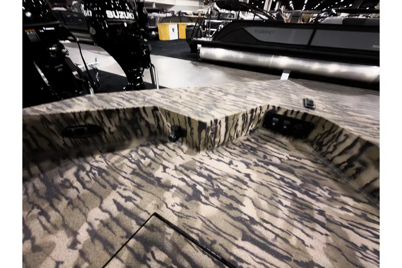 Slide: The Image of 2026 Excel 220 Bay Pro Elite boat interior with camouflage design and Suzuki outboard motor. - 20
